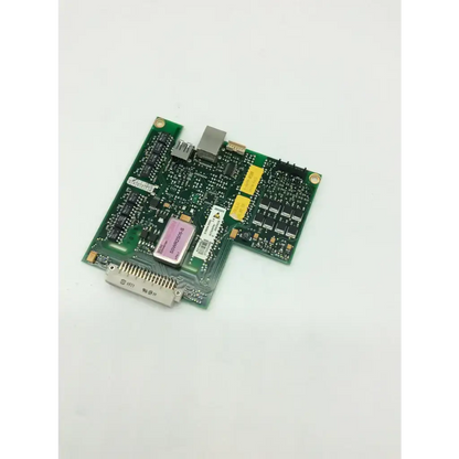 Ascom 4-0694-9500 converter board with green circuit board, pink rectangular component, black ICs, and yellow capacitors