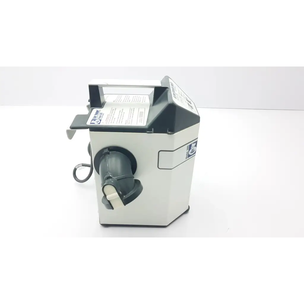 White and black countertop money counting machine with a handle on top adjacent to augustine medical bair hugger 505 patient warming unit