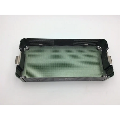 Green perforated metal surgical instrument tray with black reinforced edges and handles in autocuff opus collection shoulder case