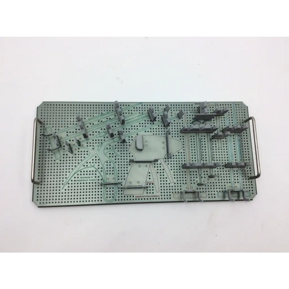 Gray perforated metal surgical instrument tray with organized slots and handles from autocuff opus collection shoulder set