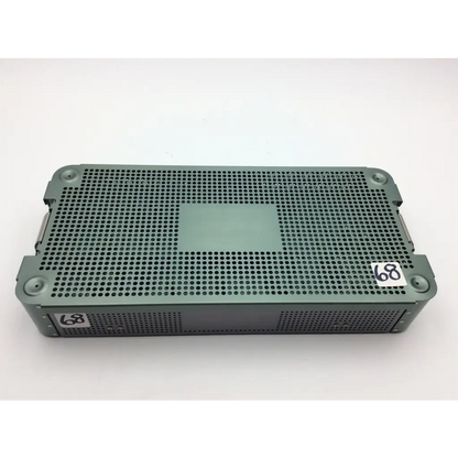 Dark green perforated metal surgical instrument tray with reinforced corners from autocuff opus collection shoulder set