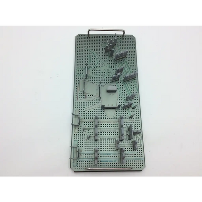 Gray metallic surgical instrument tray with perforated compartments in autocuff opus collection shoulder instrument set