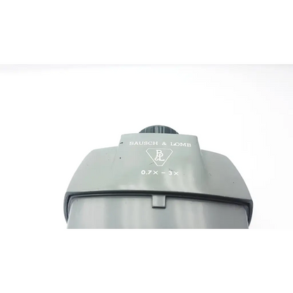 Gray plastic bausch and lomb microscope head stereozoom with 0.7x to 3x zoom range and textured focus knob