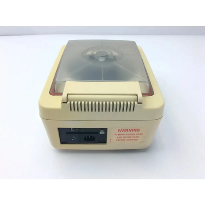 Beige plastic baxter stat 60 centrifuge af5-31 with transparent lid and ventilation slits on the front panel