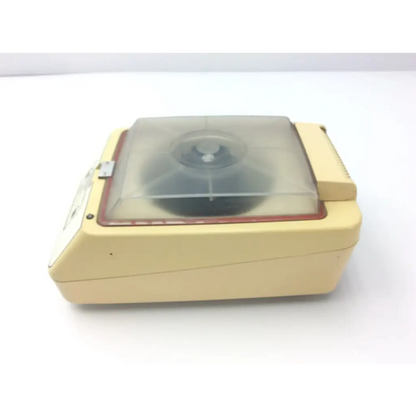 Cream-colored plastic baxter stat 60 centrifuge af5-31 with transparent lid and red trim for laboratory use