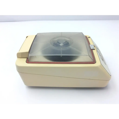 Cream-colored baxter stat 60 centrifuge with transparent lid and red trim for laboratory use model centrifuge af5-31 12723sm