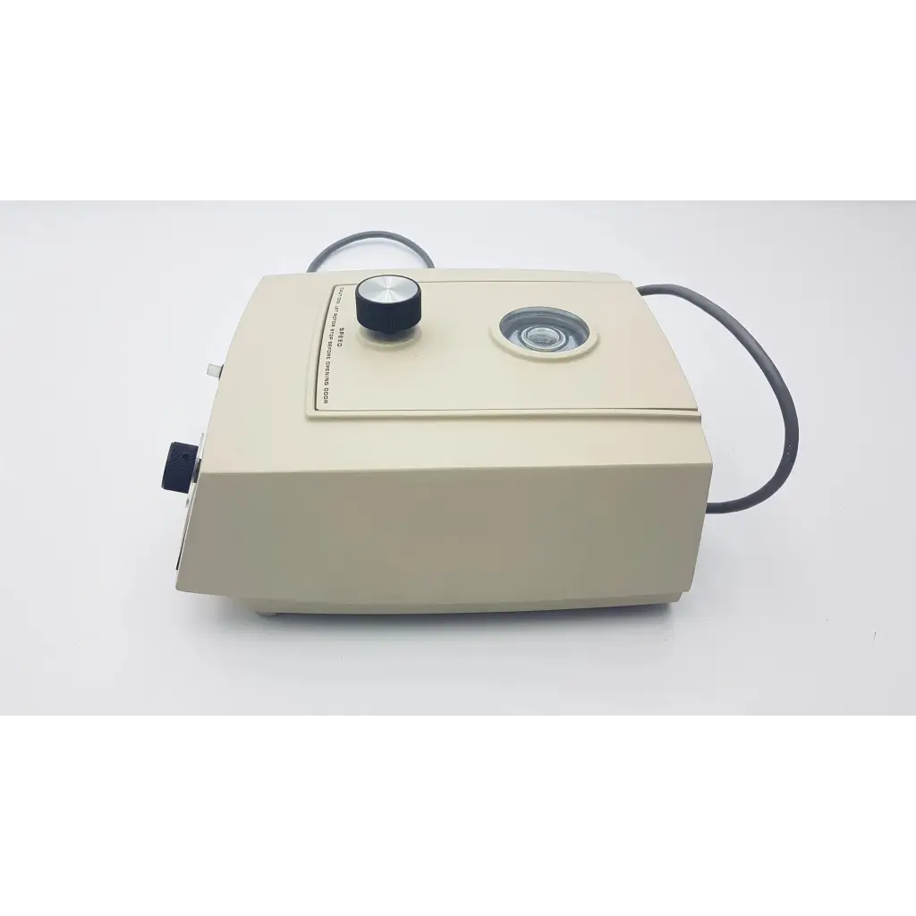 Beige dental handpiece with black rotary knob and lens on top in beckman airfuge air-driven ultracentrifuge 340400
