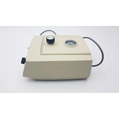 Beige dental handpiece with black rotary knob and lens on top in beckman airfuge air-driven ultracentrifuge 340400