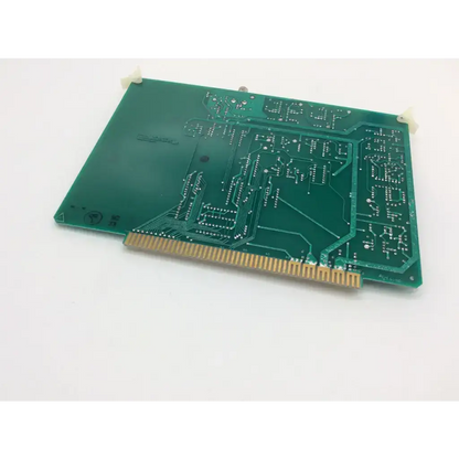 Green printed circuit board with gold connector pins and white mounting clips on becton dickinson fsc amplifier rev c