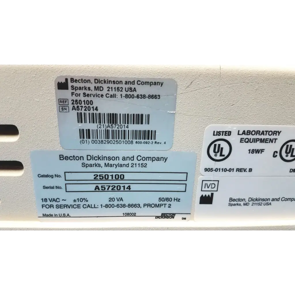 White plastic becton dickinson laboratory equipment label with black text and barcode on becton dickinson microprobe processor