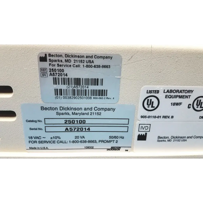 White plastic becton dickinson laboratory equipment label with black text and barcode on becton dickinson microprobe processor