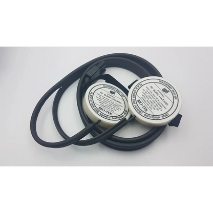 Black coiled cable with two white circular bio-tek diathermy analyzer ad5-21 pack units and safety warnings visible