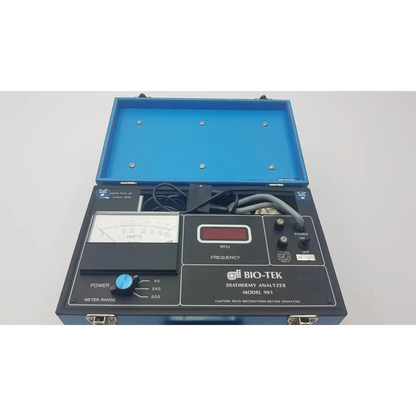 Blue hard-shell case containing bio-tek 901 diathermy analyzer with black control panel and analog watt meter