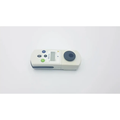 Biomerieux densichek plus handheld digital colorimeter in white and gray with circular black sample holder for density testing
