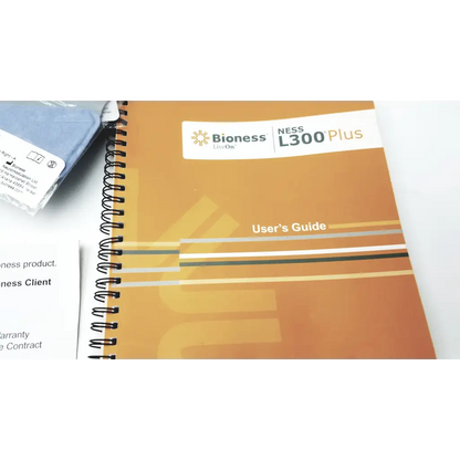 Orange spiral-bound user guide for bioness l300 plus thigh cloth electrodes showing front cover