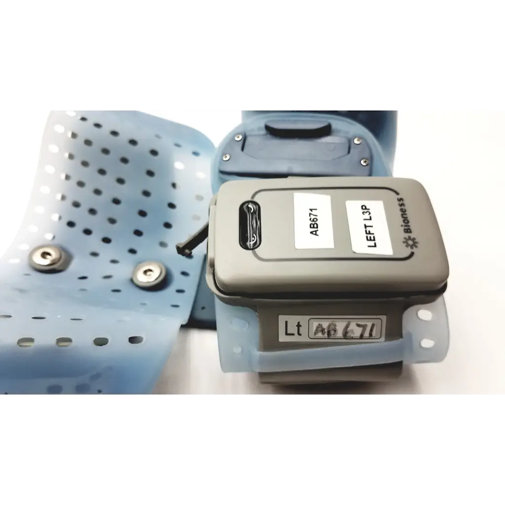 Gray bioness l300 plus l3p left leg brace with light blue perforated silicone straps and thigh cloth electrodes