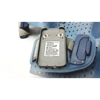 Gray rectangular bioness l300 plus thigh cloth electrodes with blue plastic components and metallic screws