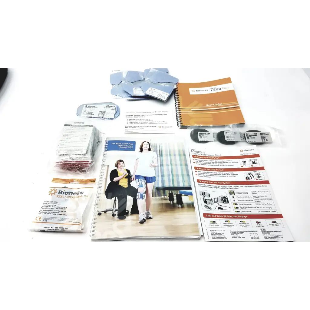 Bioness l300 plus knee support system with black thigh cloth electrodes, instructional manual, and accessory components