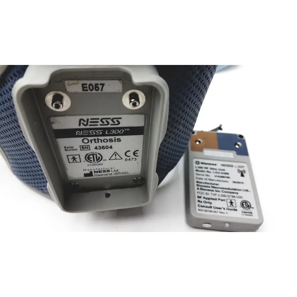 Gray plastic bioness l300 plus orthosis device with thigh cloth electrodes and white label showing model and serial number