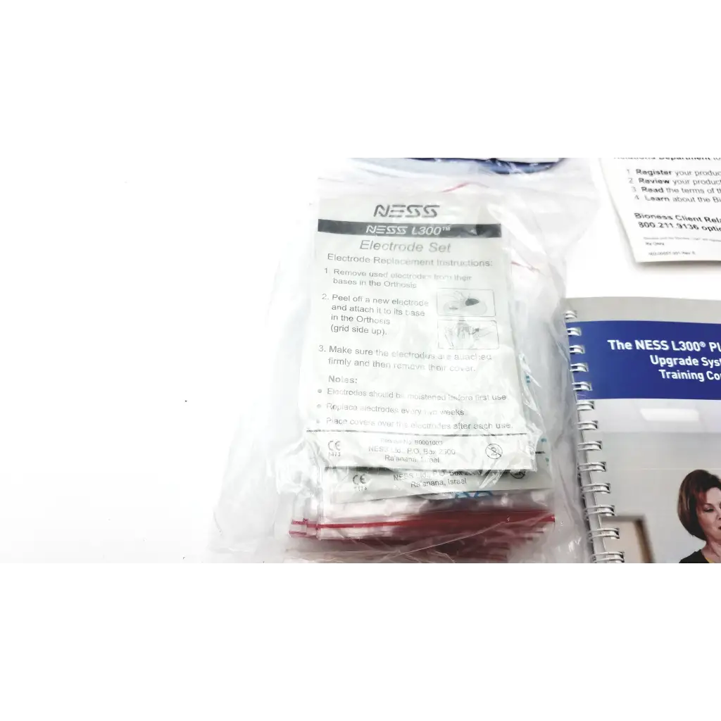 A clear plastic package of red and white thigh cloth electrodes for bioness l300 plus l3p-5d00 device