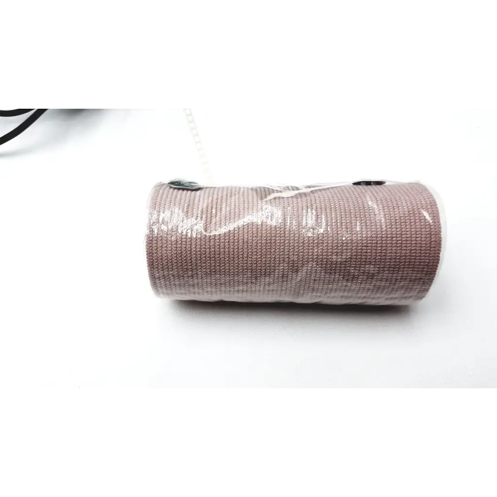 A roll of taupe textured elastic bandage wrapped in plastic for bioness l300 plus thigh cloth electrodes use