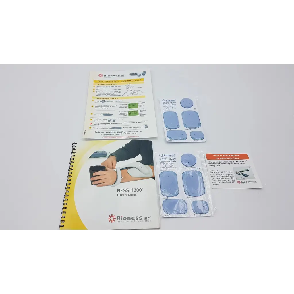 Bioness ness h200 large hand rehabilitation muscle stimulator system with blue adhesive pads and user guide visible