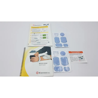 Bioness ness h200 large hand rehabilitation muscle stimulator system with blue adhesive pads and user guide visible