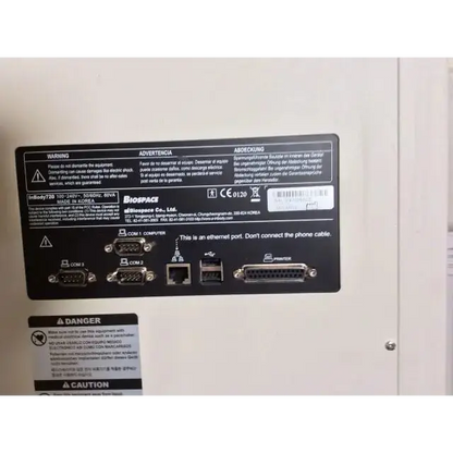 Black rectangular label on the back of biospace inbody 720 body composition analyzer showing ports for com 1 com 2 ethernet usb and printer
