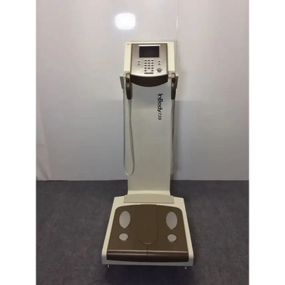 Cream-colored and brown biospace inbody 720 body composition analyzer with digital display keypad and measurement straps