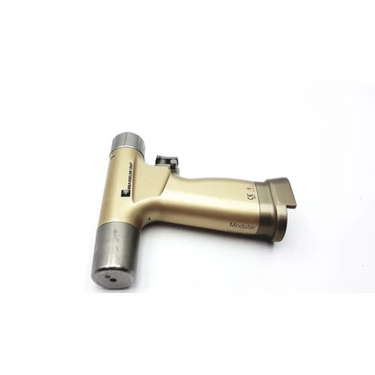 Gold-colored brasseler modular orthopedic surgical handpiece with metallic finish and silver accents for precision use