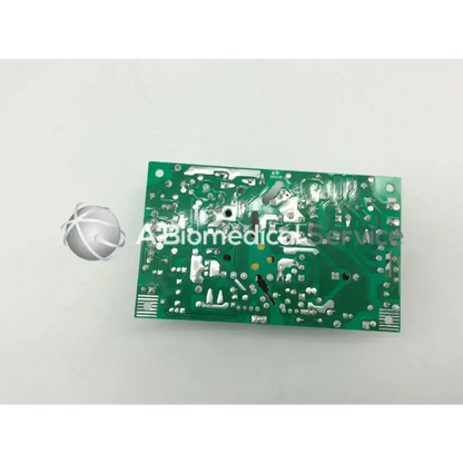 Green rectangular circuit board with silver soldered components and printed markings for transformer 5117312-0a00 rev