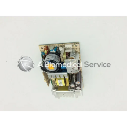 Silver and black electronic power supply module with capacitors and circuitry on beige board transformer 5117312-0a00 rev