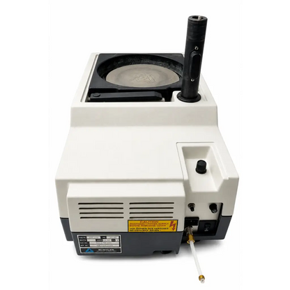 White and black biomed certified buehler ecomet 3 variable speed grinder-polisher with circular platform labeled schlumberger