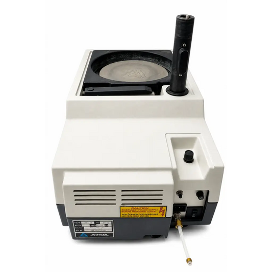White and black buehler ecomet 3 variable speed grinder-polisher with circular platform labeled schlumberger