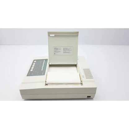Beige burdick e350i electrocardiograph machine with hinged lid control panel and paper output tray for cardiac monitoring