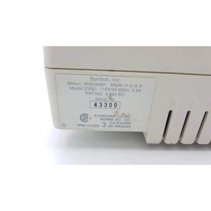 White plastic burdick e350i electrocardiograph device with manufacturer label showing model e350i and serial 43300