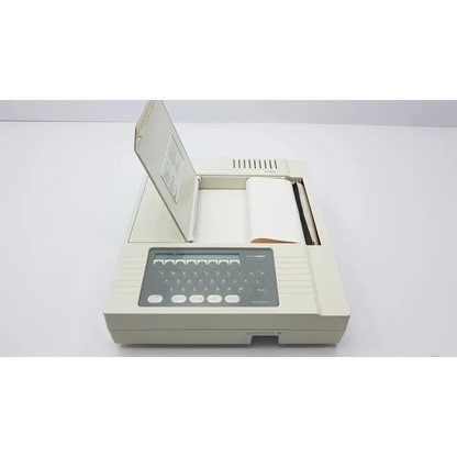 Beige burdick e350i electrocardiograph machine with digital keypad and paper output tray for cardiac monitoring