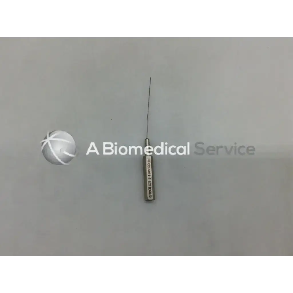 A metallic byron col-mini ii-s infiltration cannula style needle with a slender sharp point and engraved cylindrical handle