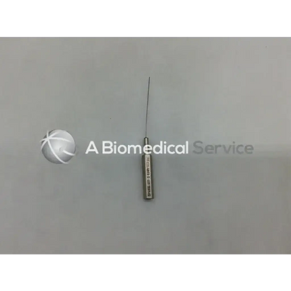 A metallic byron col-mini ii-s infiltration cannula style needle with a slender sharp point and engraved cylindrical handle