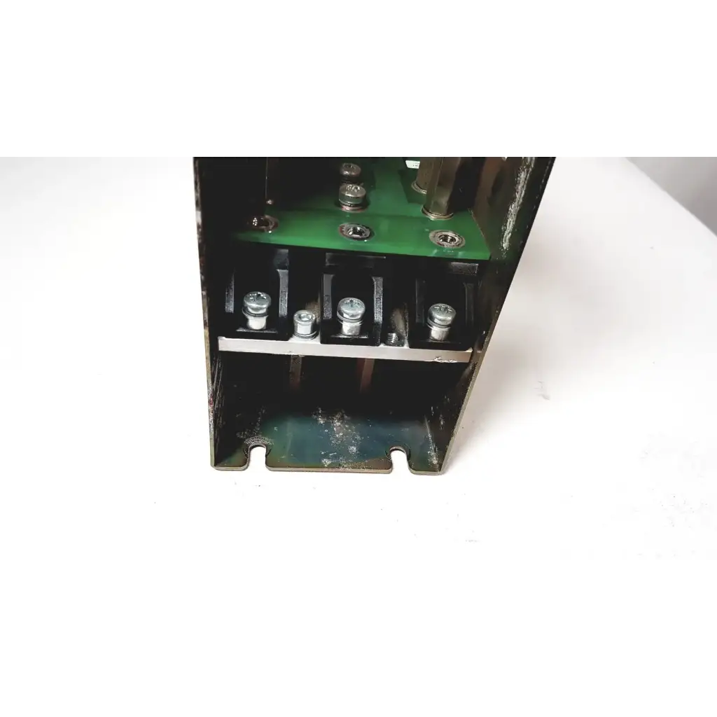 Black metal electrical enclosure showing green circuit board and silver terminal screws of bystronic module vm 50a 300v power supply