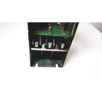 Black metal electrical enclosure showing green circuit board and silver terminal screws of bystronic module vm 50a 300v power supply