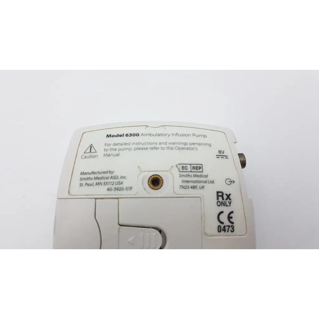 White plastic cadd-legacy 6300 pump ac5-376 ambulatory infusion pump with labels and regulatory markings