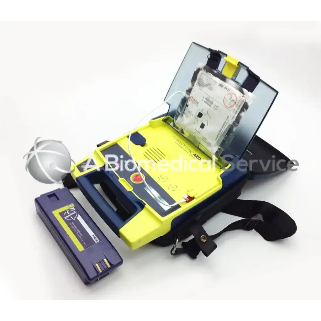 Yellow and blue cardiac science aed power heart g3 with clear lid black strap and attached battery pack in carry case