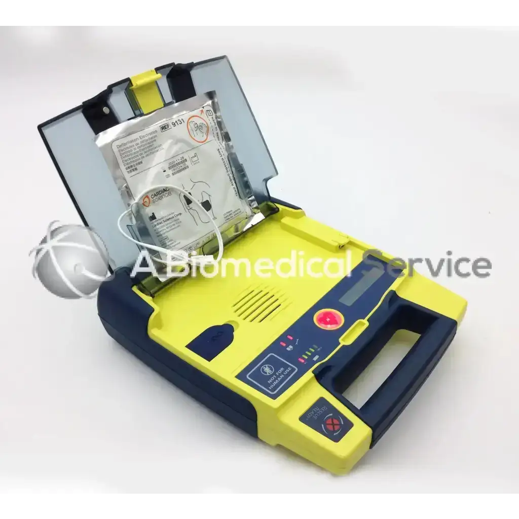 Yellow and navy blue cardiac science aed power heart g3 with open case showing built-in battery pack for emergency use