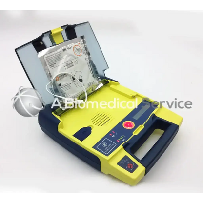 Yellow and navy blue cardiac science aed power heart g3 with open case showing built-in battery pack for emergency use