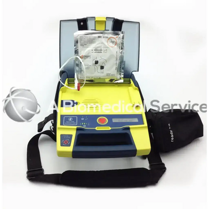 Yellow and blue cardiac science aed power heart g3 with digital display red button and black carrying strap