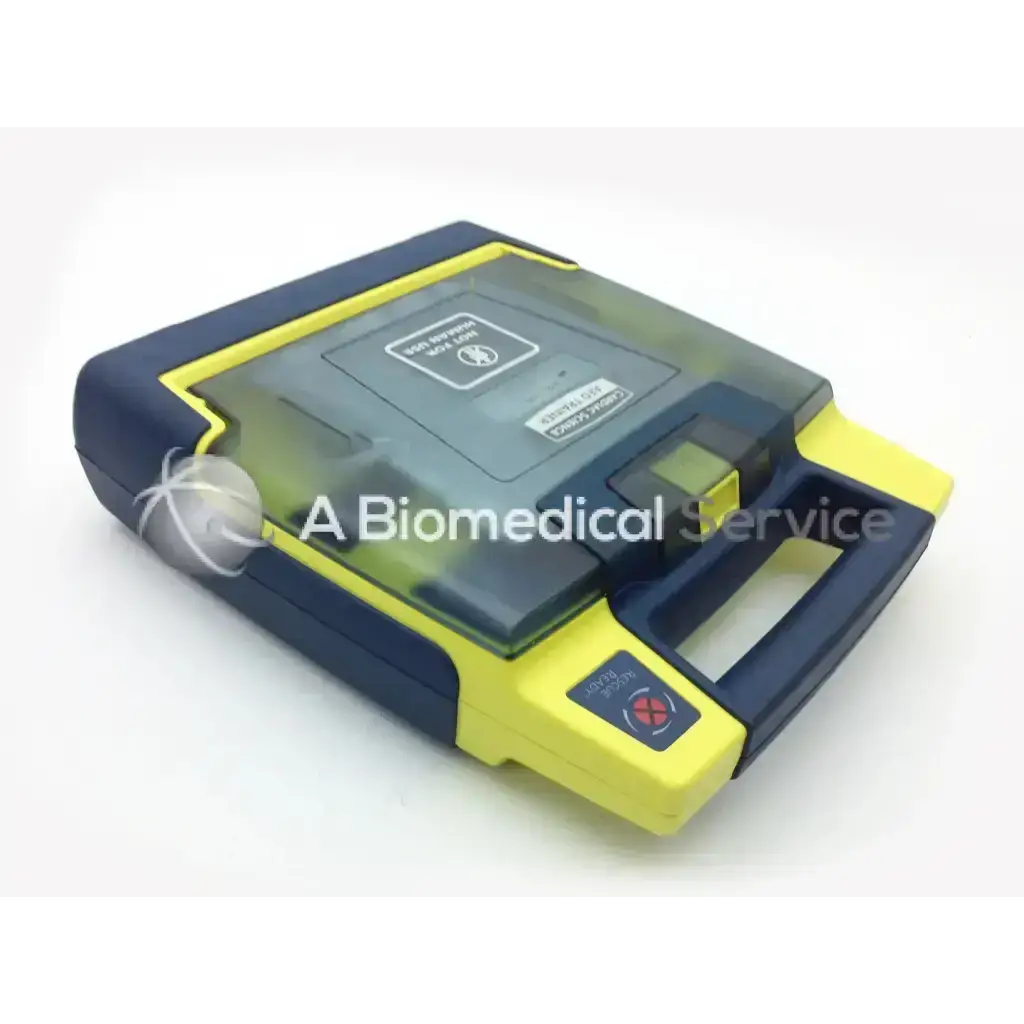 Yellow and navy blue cardiac science aed power heart g3 portable defibrillator with transparent lid and red shock button