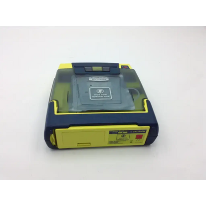 Yellow and navy blue cardiac science aed trainer with transparent lid showing internal components for training use