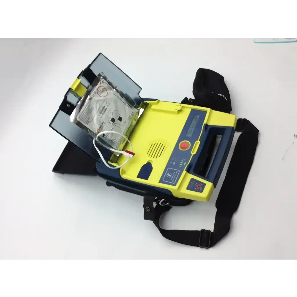 Yellow and blue cardiac science aed trainer with pads case and black carrying strap for emergency use