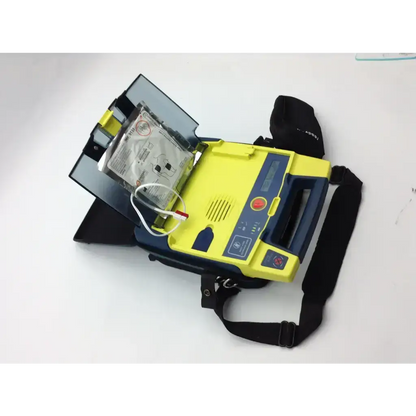 Yellow and blue cardiac science aed trainer with pads case and black carrying strap for emergency use